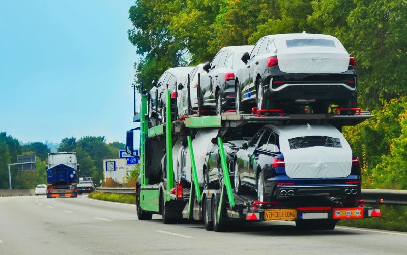 A trailer of vehicles transported on an open trailer