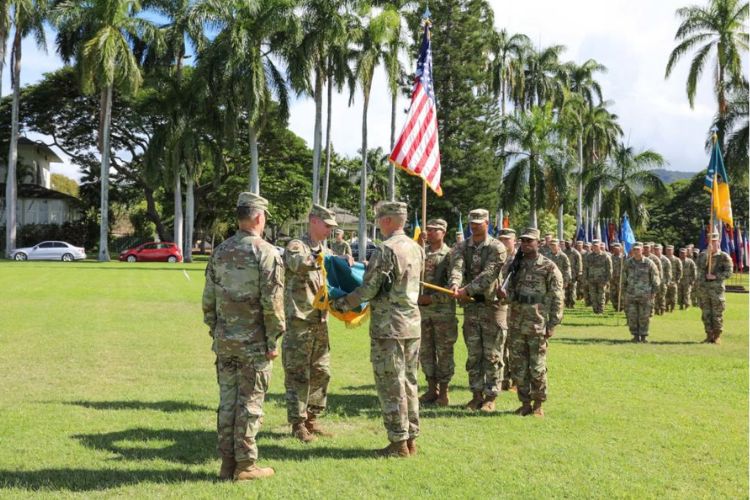 Military change of command ceremony at Fort Shafter with soldiers in formation, flag exchange, and U.S. flag in the background.