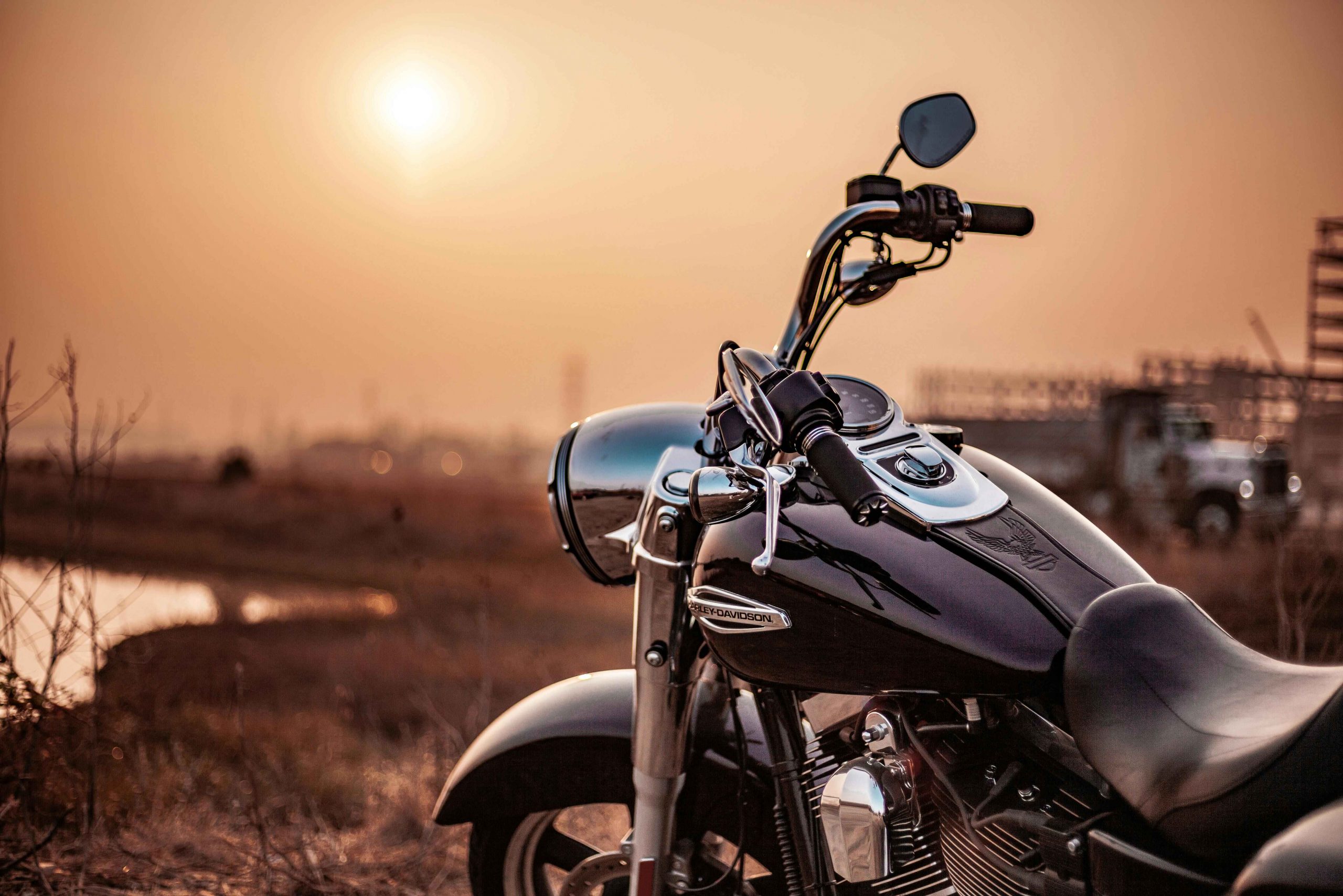 A close-up of a motorcycle during sunset