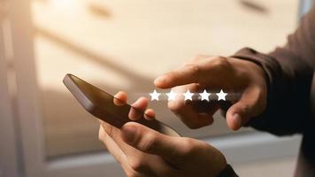 Person holding phone and selecting five-star review