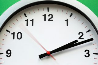 Black and white clock pointed to 2:12