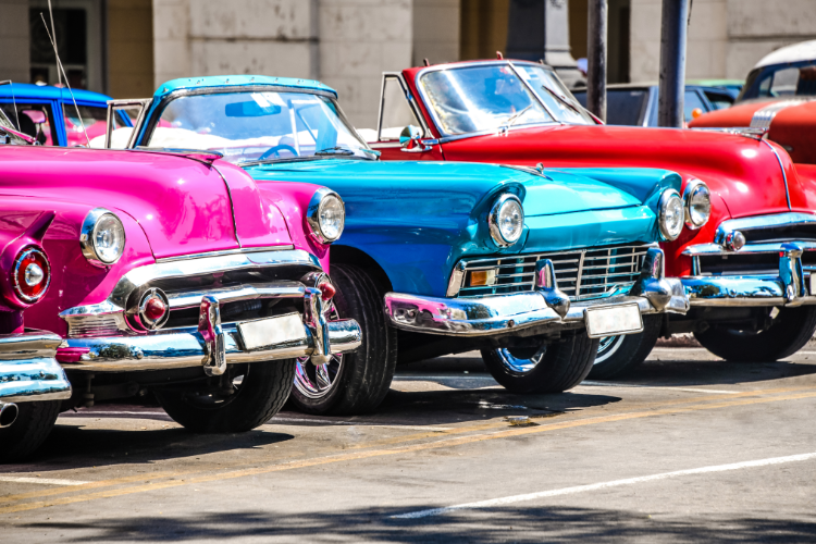 Colorful vintage convertible cars parked in row