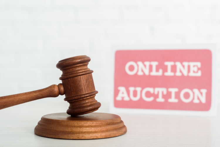 Gavel beside online auction sign