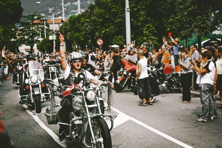 Excited bikers riding through cheering crowd