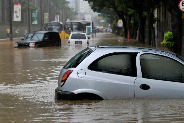 Flooded city street with partially submerged car