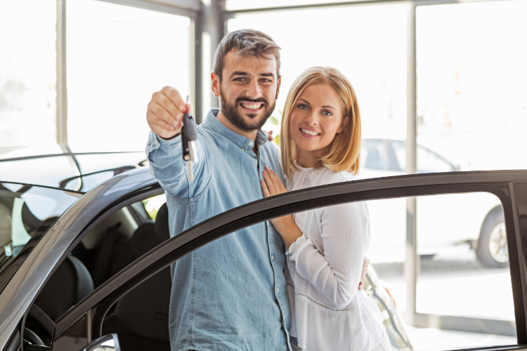 Happy couple receives new car keys