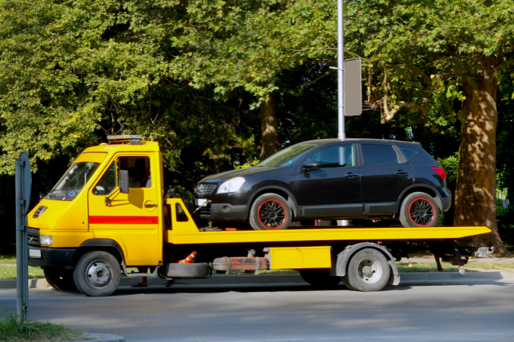 Yellow Tow Truck Carrying Black Car