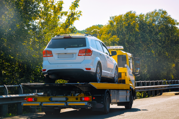 Flatbed Tow Truck Transporting White SUV