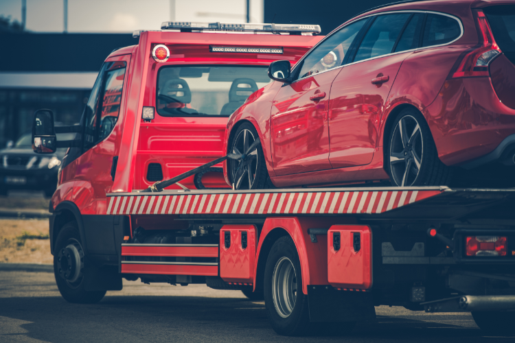 Red Car Loaded On Tow Truck