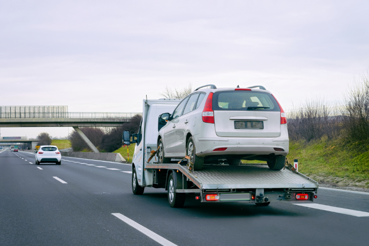 White Car Being Towed On Highway