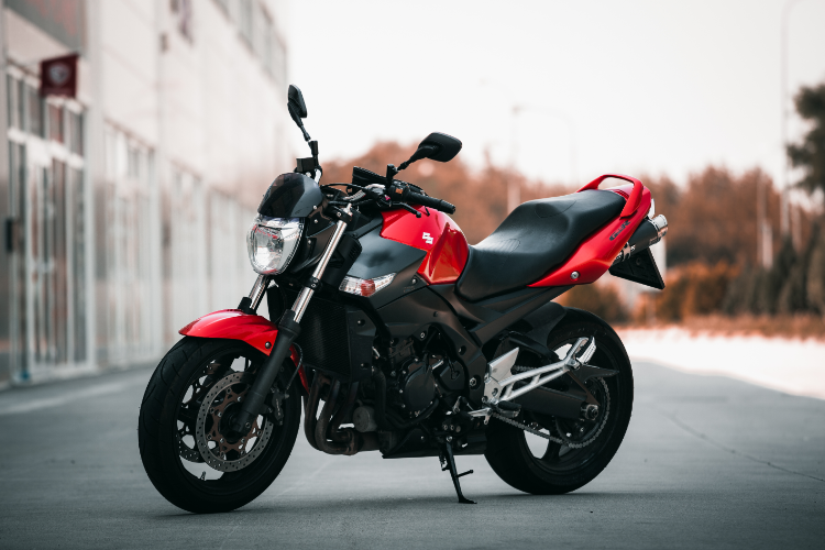 Red and black sport motorcycle parked outdoors