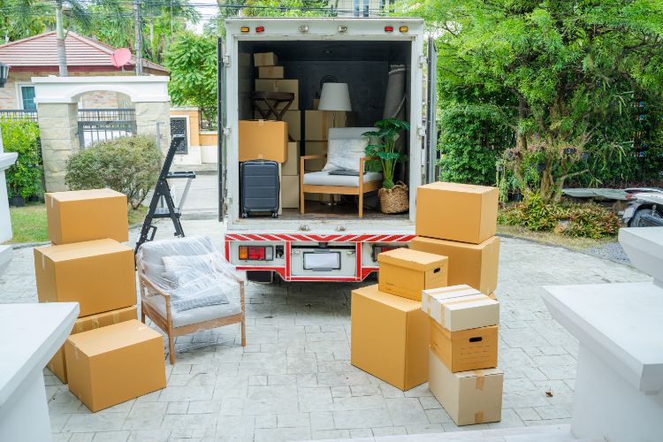 Moving Truck Loaded With Boxes And Furniture