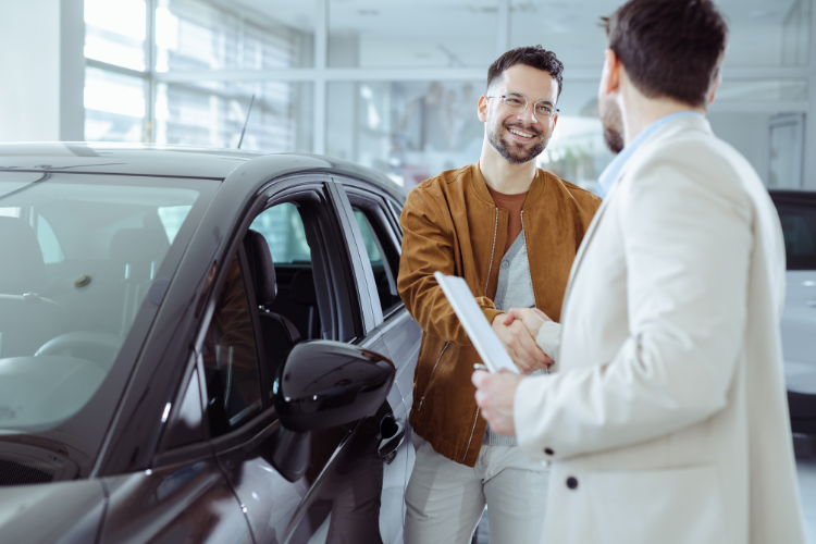 Happy Customer Shaking Hands After Car Sale