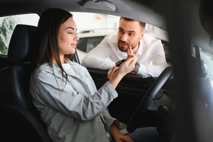 Woman Receiving Car Keys After Purchase