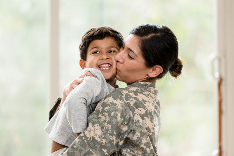 Military Mother Hugging Child In Hawaii