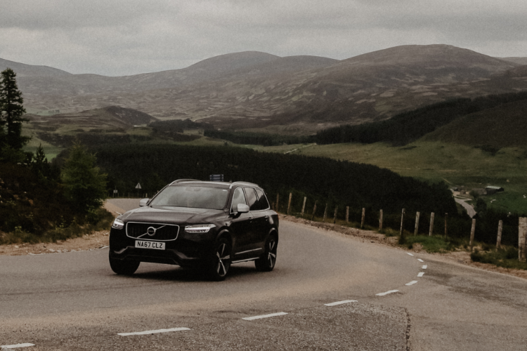 Affordable SUV Driving Through Mountain Road