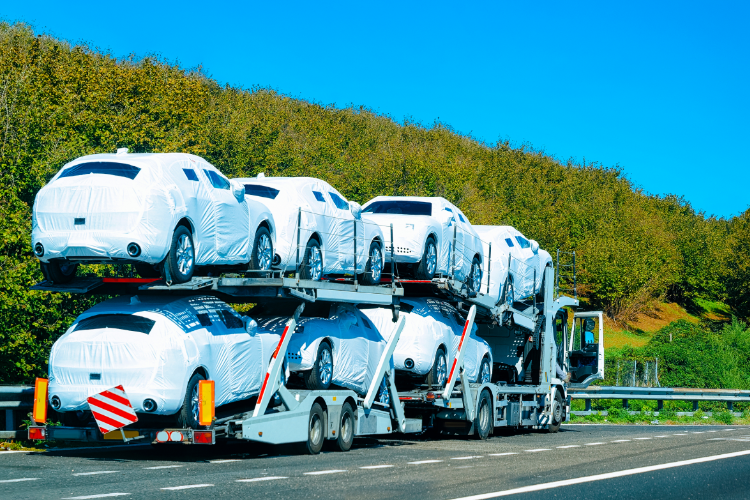 Car carrier truck transporting wrapped vehicles