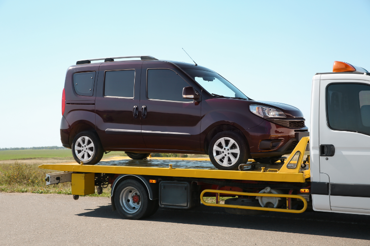 Brown Van Loaded On Yellow Tow Truck