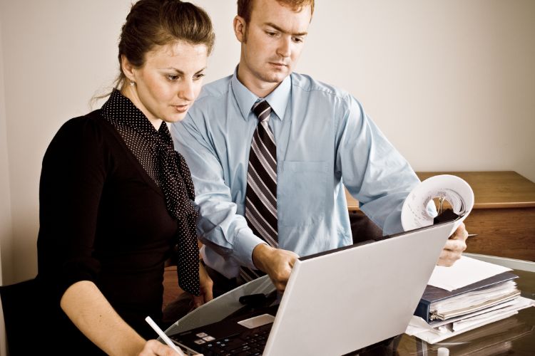Couple Reviewing Laptop To Verify Transport