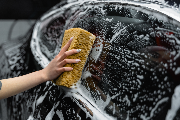 Washing Car Window With Cleaning Sponge