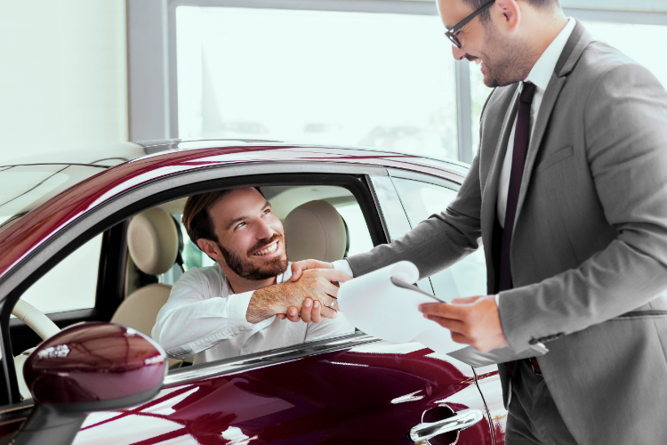 Customer Buying Car At Dealership Showroom