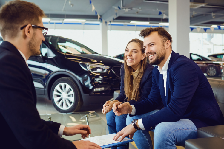 Couple Discussing Car Purchase With Salesperson