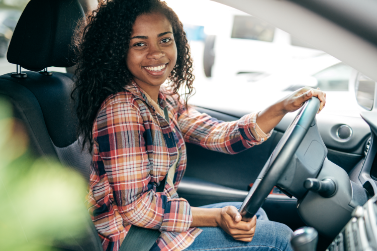 Smiling Woman Driving Car After Getting IDP