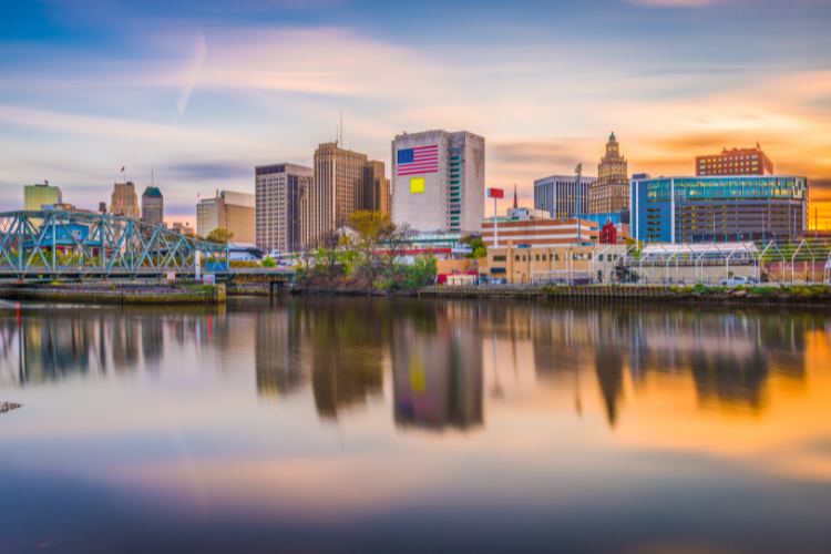 Newark Skyline Reflected In River At Sunset