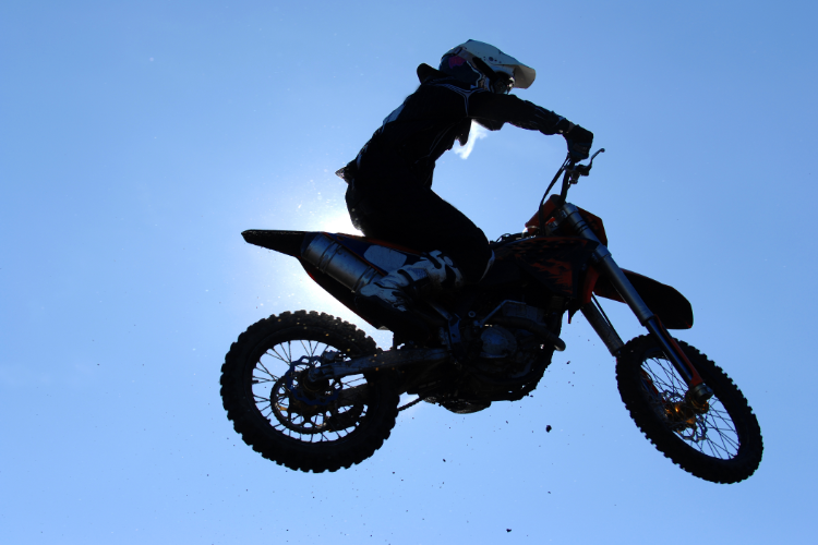 Adventure Motorcycle Rider Jumping In Air