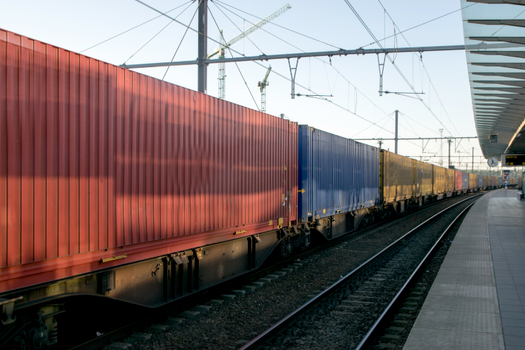 Freight Train Carrying Containers At Station