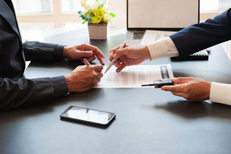 Customer Reviewing And Signing Car Lease Documents