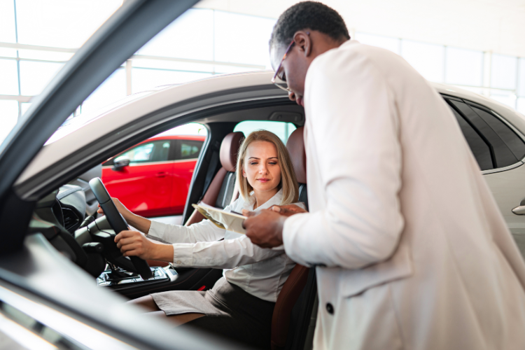 Customer Reviewing Car Purchase At Dealership