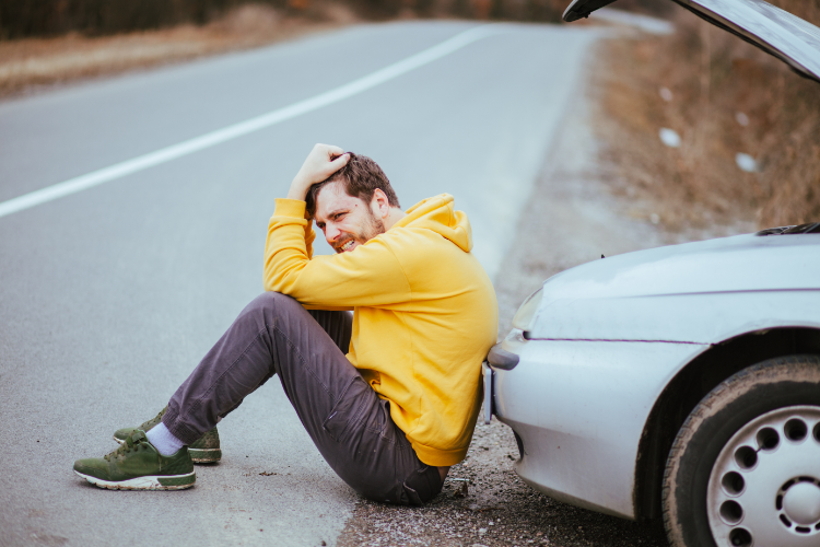 Worried Man Sitting Beside Used Car