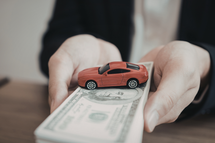 Hands Holding Cash And Toy Car